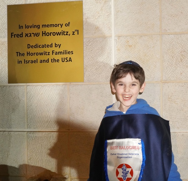 Grandson at the plaque.