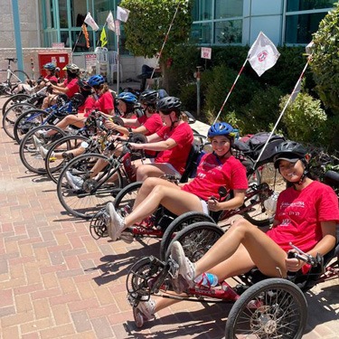 Maccabiah athletes try out handbikes at Beit Halochem.